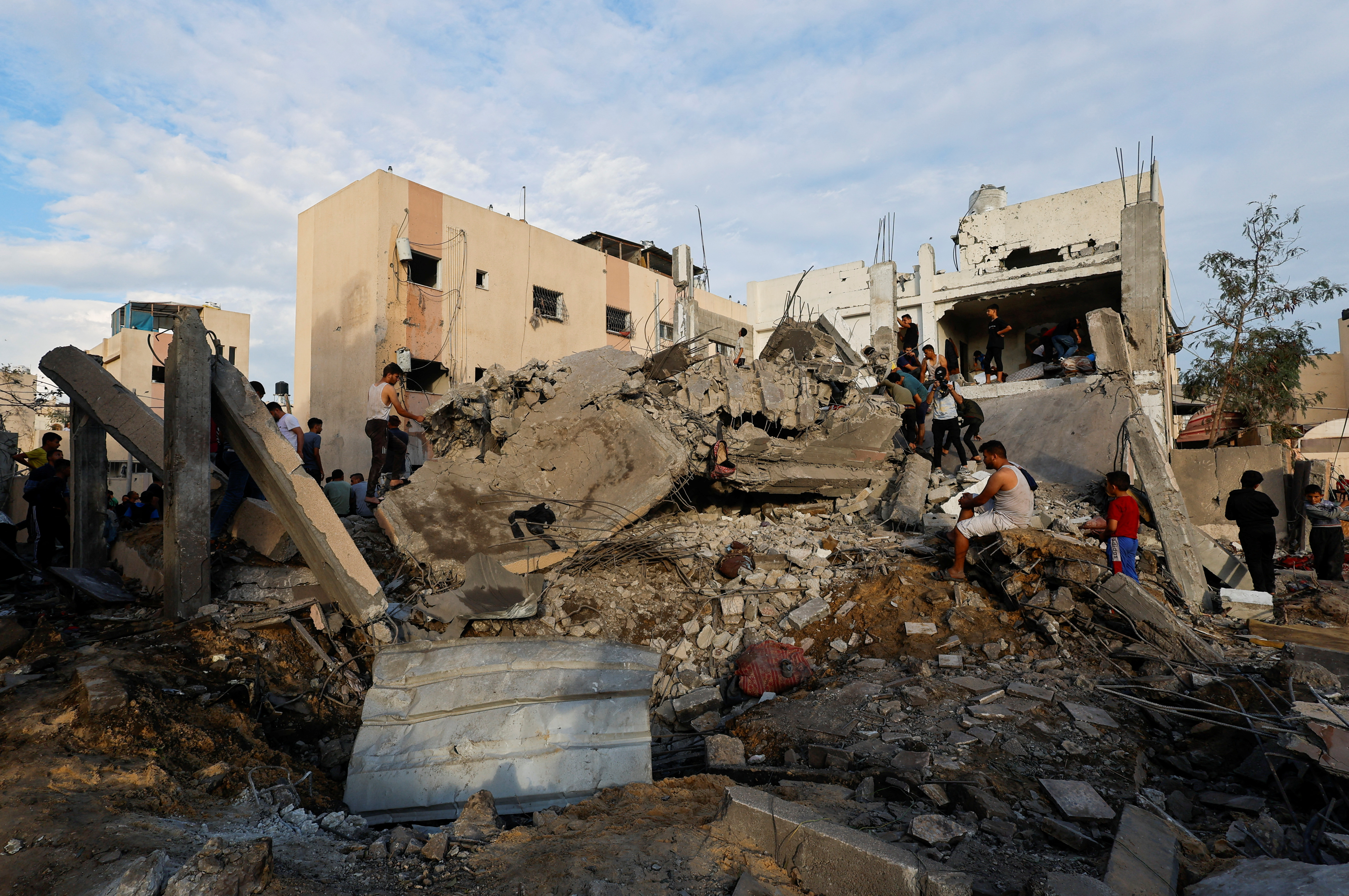 Palestinians search for casualties under the rubble of a building destroyed by Israeli strikes in Khan Younis in the southern Gaza Strip, Tuesday.