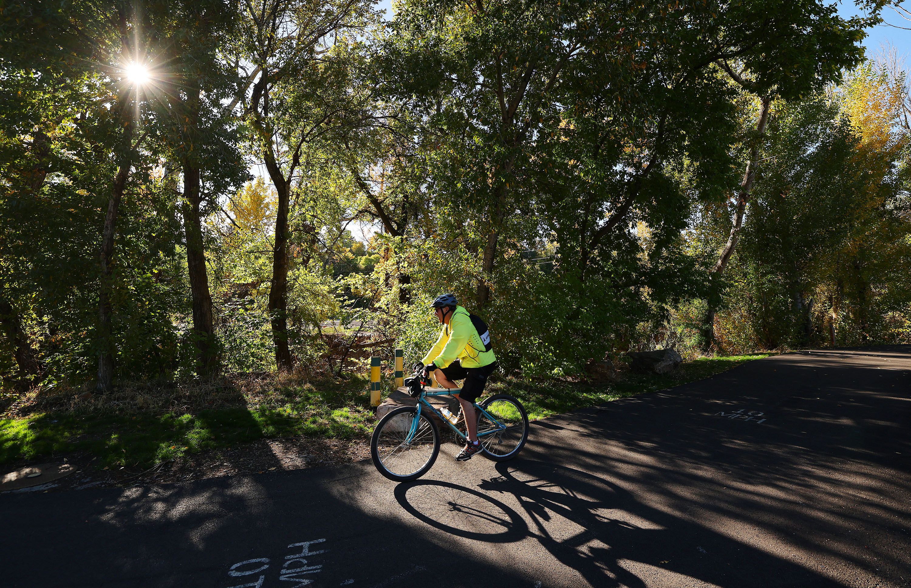 A cyclist rides on the Centennial Trail along the Ogden River in Ogden on Tuesday. Legislative discussions are underway to protect riparian corridors as part of county and city plans.