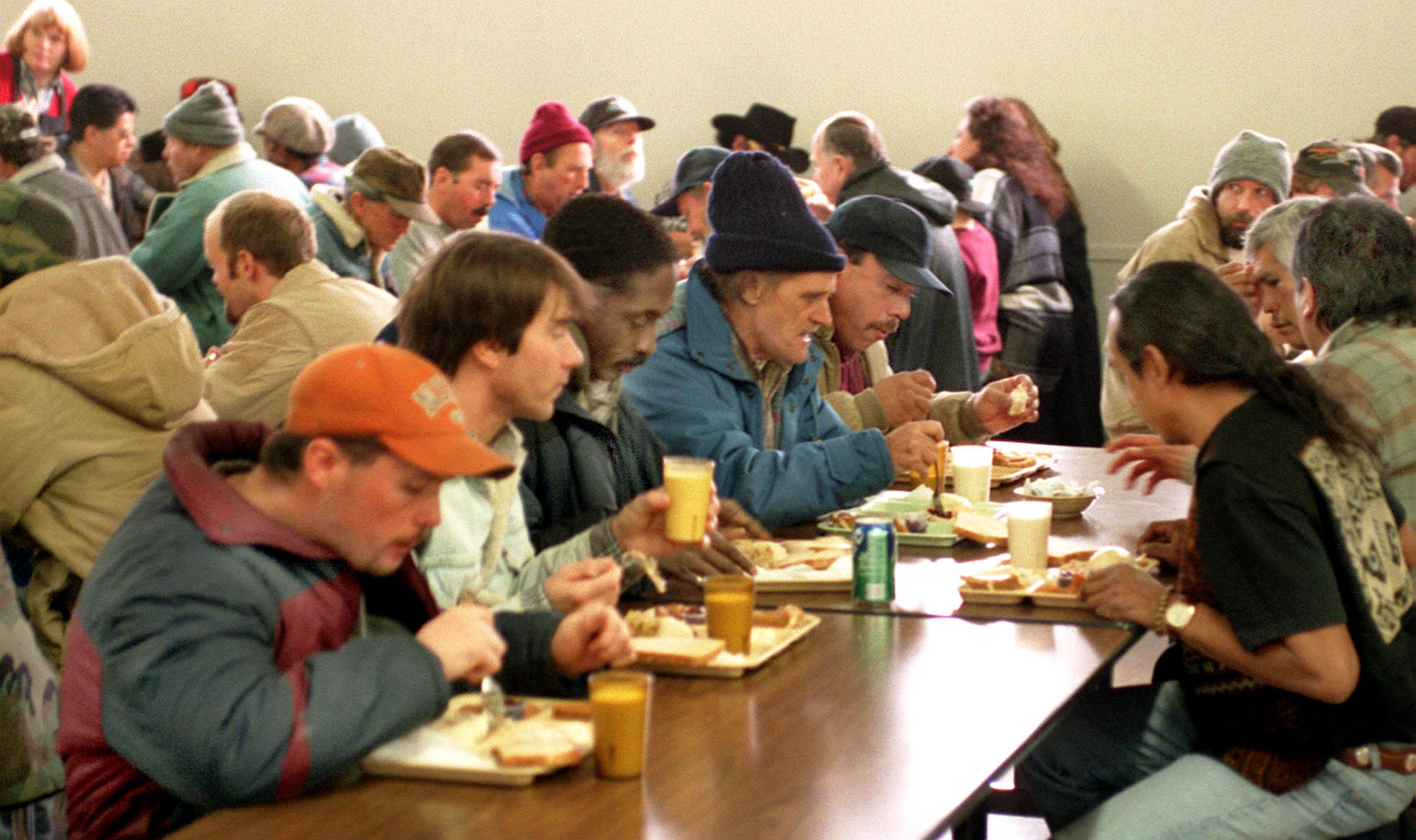 Unsheltered individuals are seen having lunch at St. Vincent de Paul Center. The center opened Monday for winter overflow, adding 65 temporary beds for the season.