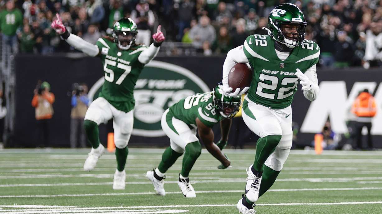 New York Jets' Tony Adams, right, runs with the ball after an interception during the second half of an NFL football game against the Philadelphia Eagles, Sunday, Oct. 15, 2023, in East Rutherford, N.J.