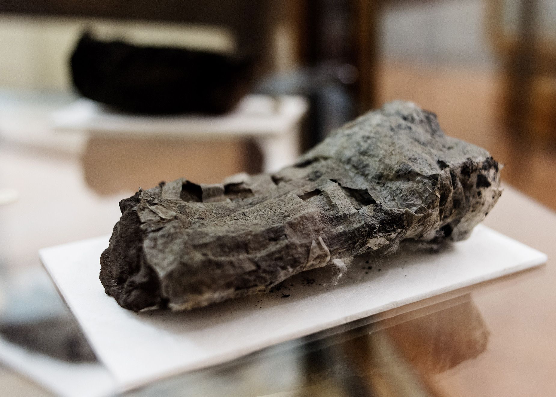 By using computer tomography and advanced artificial intelligence, researchers have been able to read the first full word off of an unwrapped ancient Herculaneum scroll.