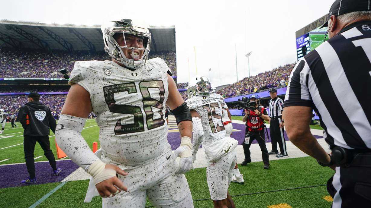 Oregon offensive lineman Jackson Powers-Johnson reacts after wide receiver Tez Johnson (15) made a two point conversion catch against Washington during the second half of an NCAA college football game, Saturday, Oct. 14, 2023, in Seattle.