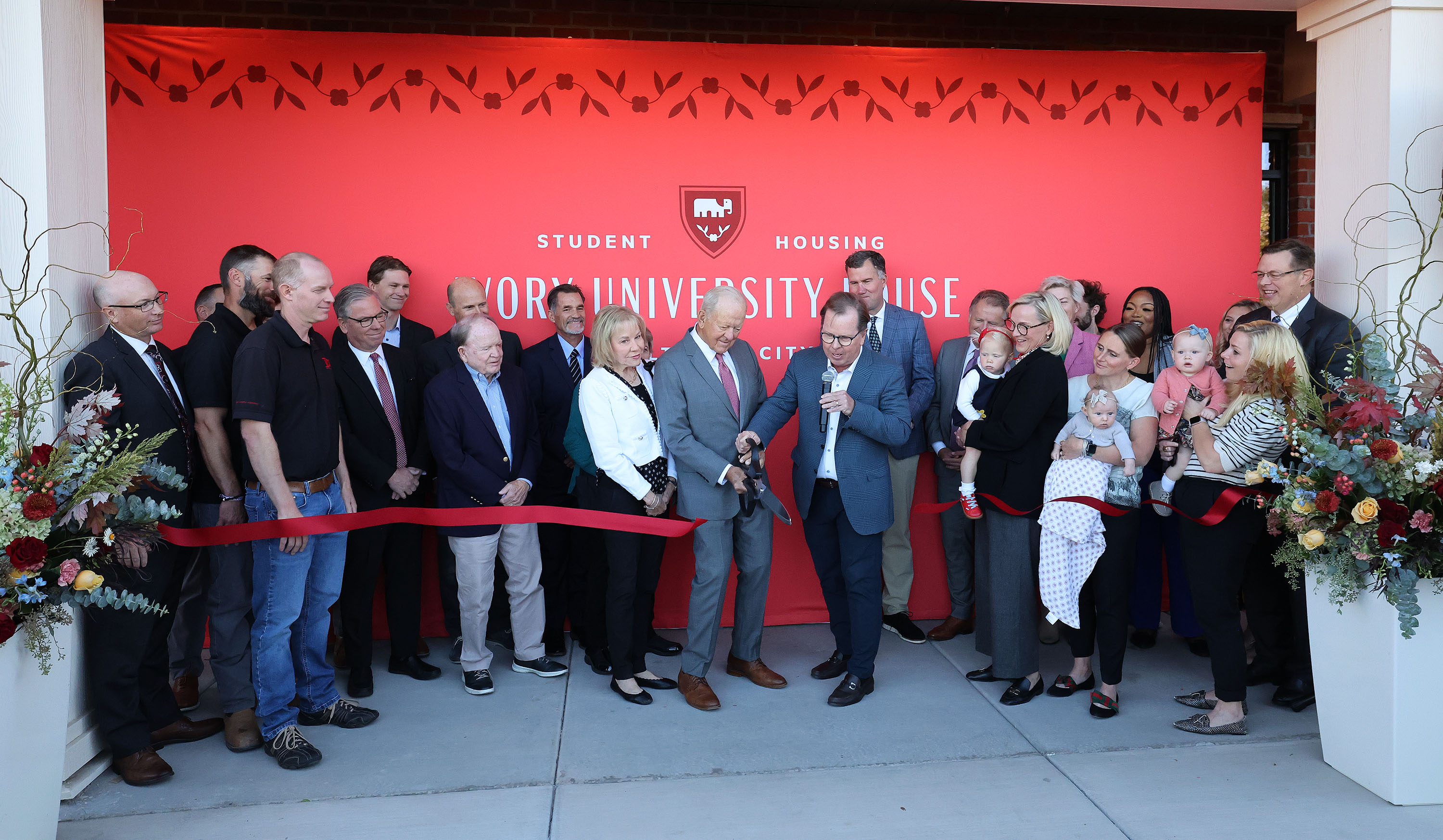 Roger Boyer, center left, and Clark Ivory cut the ribbon as the University of Utah, Ivory Family and The Church of Jesus Christ of Latter-day Saints celebrate the completion of the first of four student housing buildings at Ivory University House in Salt Lake City on Wednesday.