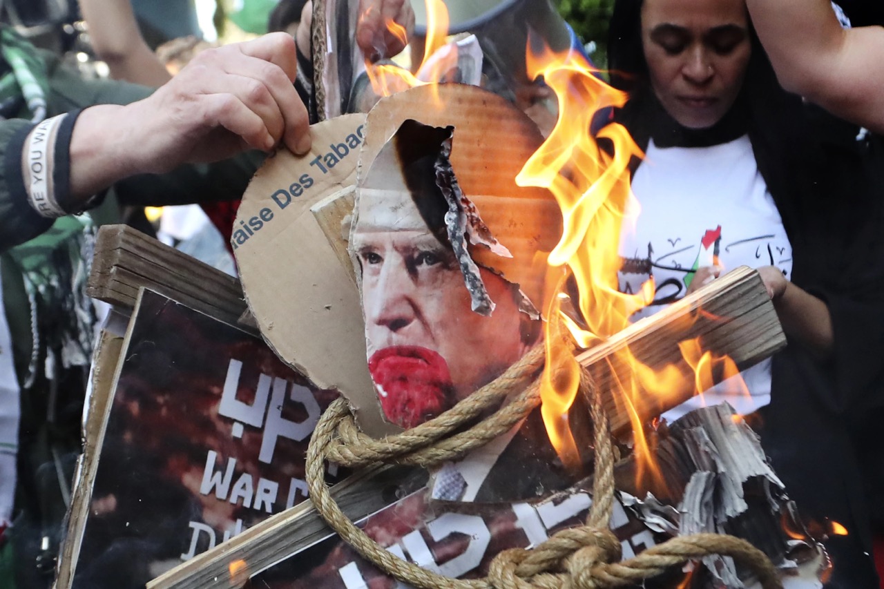 Palestinian protesters burn pictures that show President Joe Biden during a protest in solidarity with the Palestinian people in Gaza, at the Palestinian refugee camp of Ein el-Hilweh, south Lebanon, Wednesday.