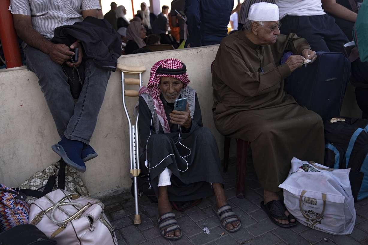 Palestinians wait to cross into Egypt at the Rafah border crossing in the Gaza Strip, on Monday.