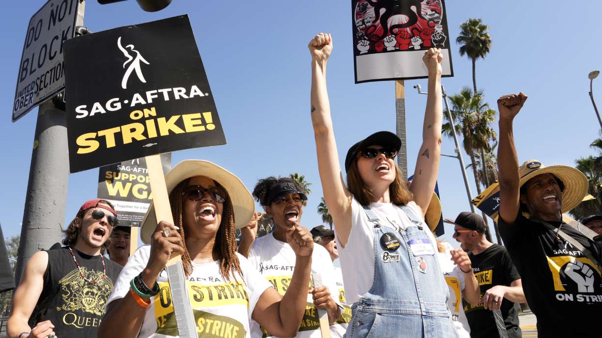 Striking actors Jennifer Leigh Warren, left, and Emily Kincaid, right, demonstrate outside Netflix studios, Tuesday in Los Angeles. Film and TV actors are still on strike in what has become the longest walk-off in their history.