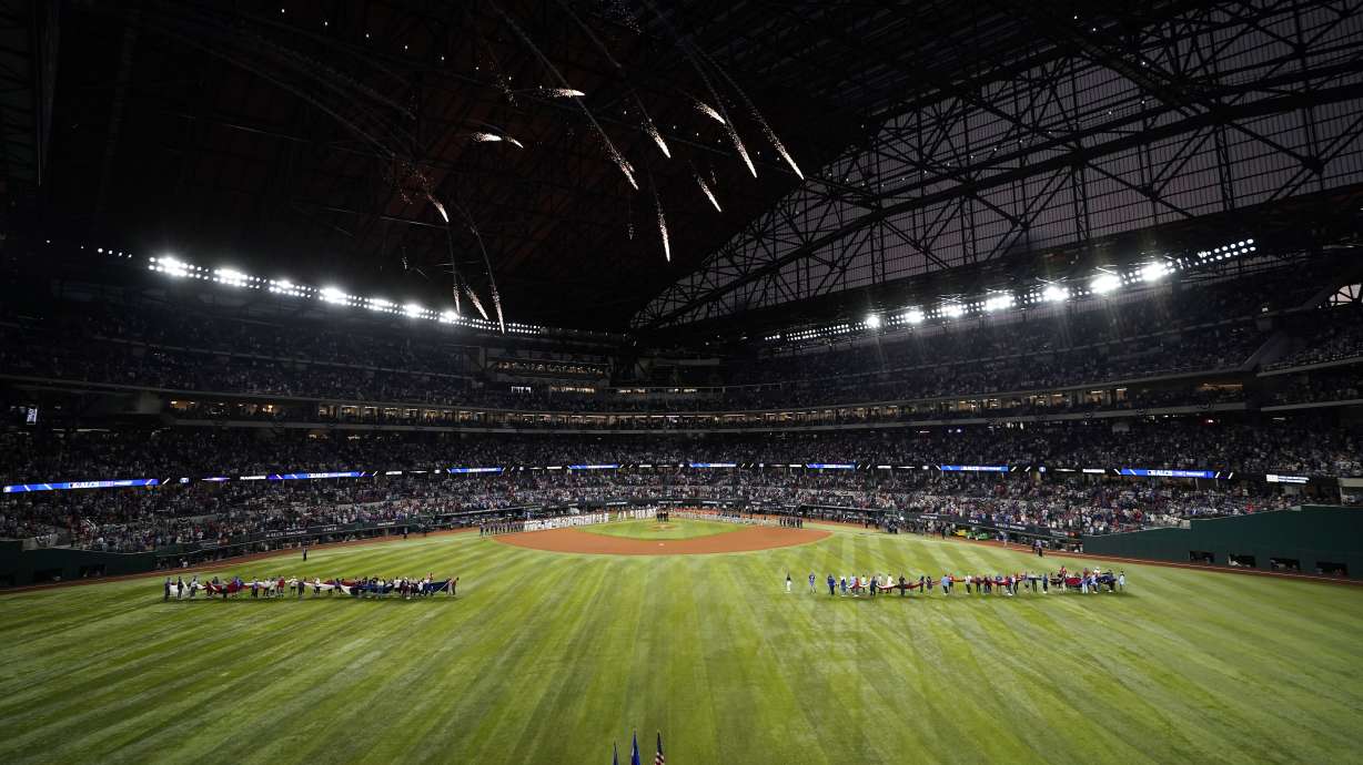 The Houston Astros and Texas Rangers line up before Game 3 of the baseball American League Championship Series Wednesday, Oct. 18, 2023, in Arlington, Texas.