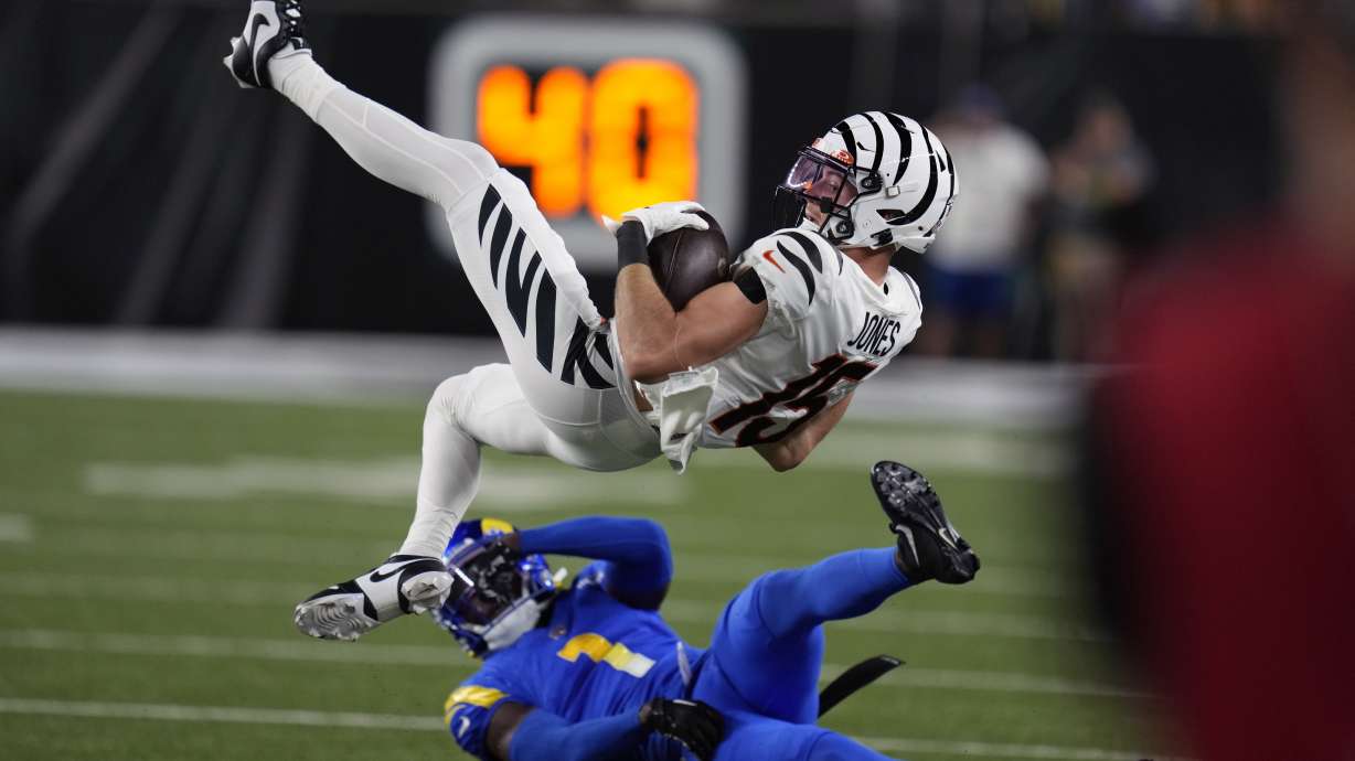 Cincinnati Bengals wide receiver Charlie Jones (15) is upended by Los Angeles Rams defensive back Derion Kendrick (1) during the first half of an NFL football game Monday, Sept. 25, 2023, in Cincinnati.