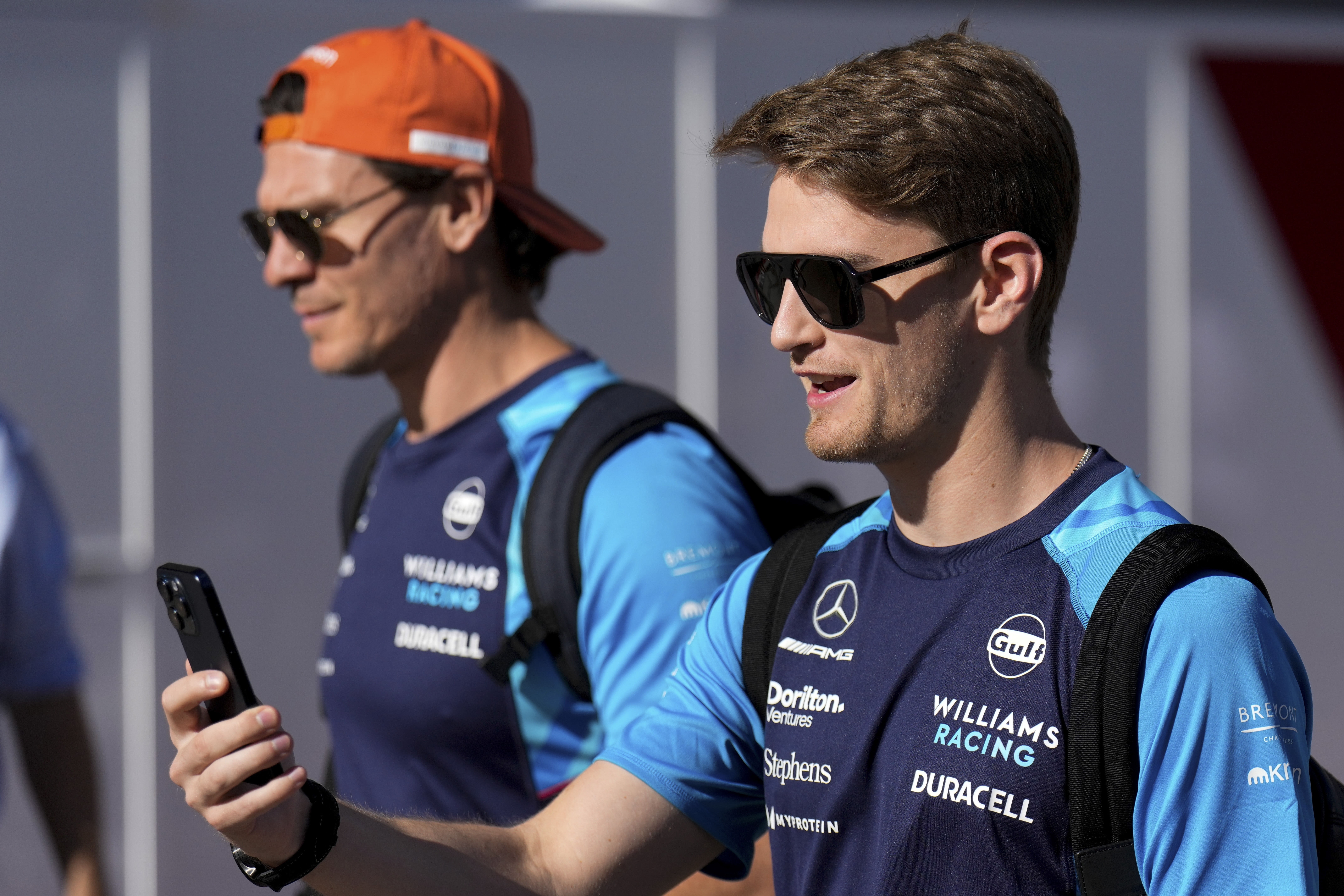Williams driver Logan Sargeant of the United States talks on his phone in the paddock ahead of a practice session for the Formula One U.S. Grand Prix auto race at Circuit of the Americas, Saturday, Oct. 21, 2023, in Austin, Texas.