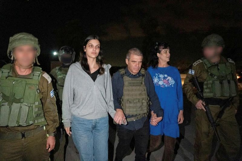 Judith Tai Raanan and her daughter Natalie Shoshana Raanan, U.S. citizens who were taken as hostages by Palestinian Hamas militants, walk while holding hands with retired Brig. Gen. Gal Hirsch, Israel's coordinator for the captives and missing, after they were released by the militants, in response to Qatari mediation efforts, in this handout picture obtained by Reuters on Friday.