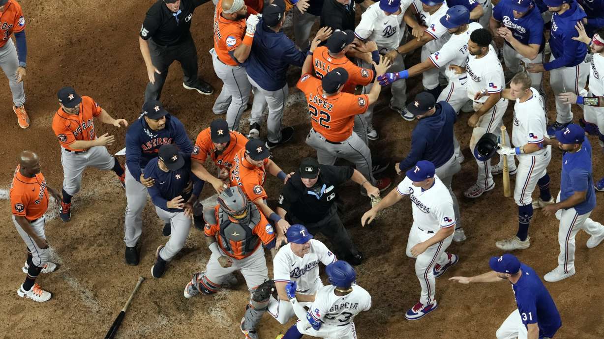 Players from Houston Astros and Texas Rangers clear the benches after Texas Rangers' Adolis Garcia was hit by a pitch thrown by Houston Astros relief pitcher Bryan Abreu during the eighth inning in Game 5 of the baseball American League Championship Series Friday, Oct. 20, 2023, in Arlington, Texas.