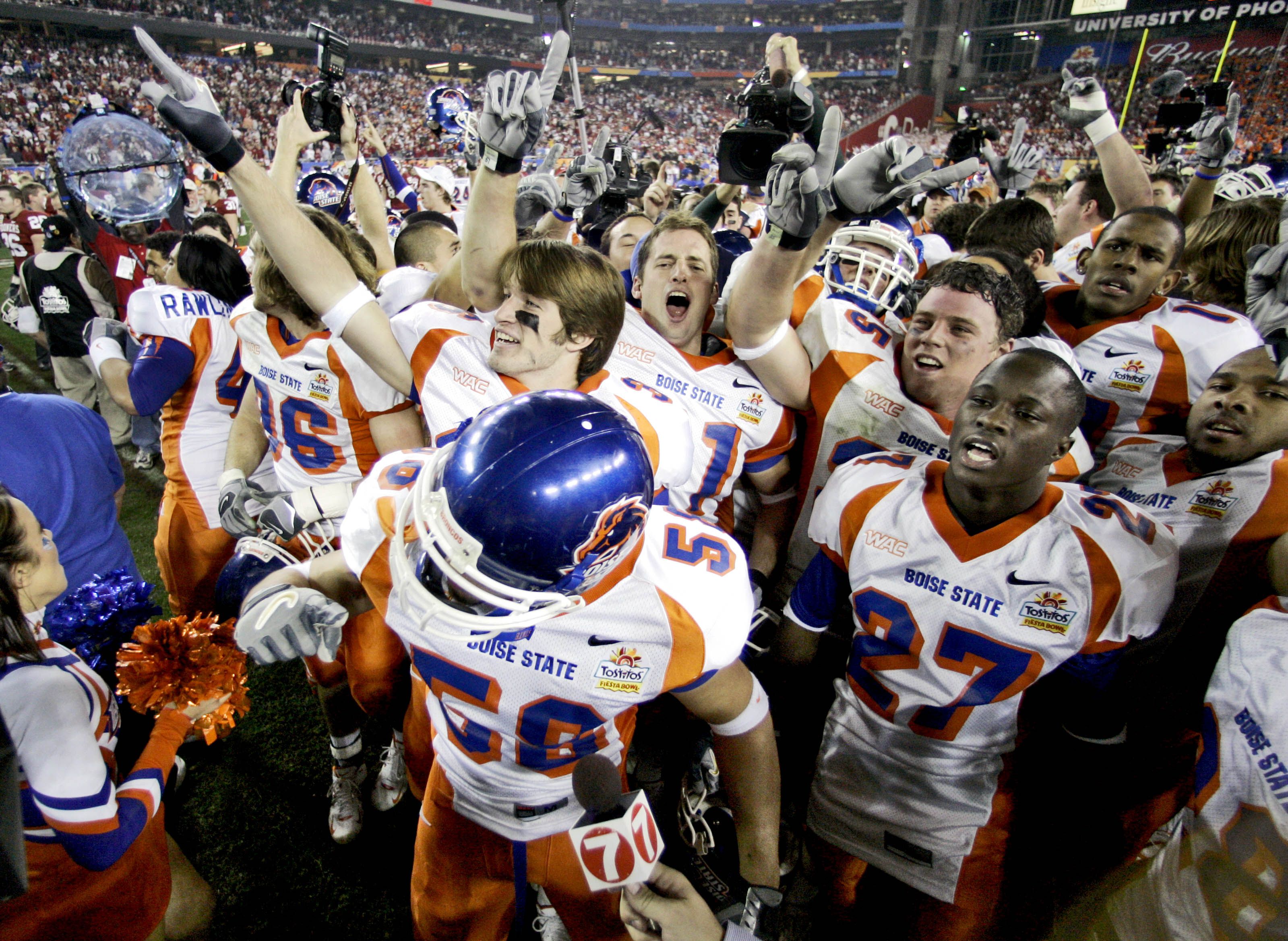 In this Jan. 1, 2007, file photo, Boise State players celebrate after defeating Oklahoma 43-42 in overtime in the Fiesta Bowl college football game in Glendale, Ariz.