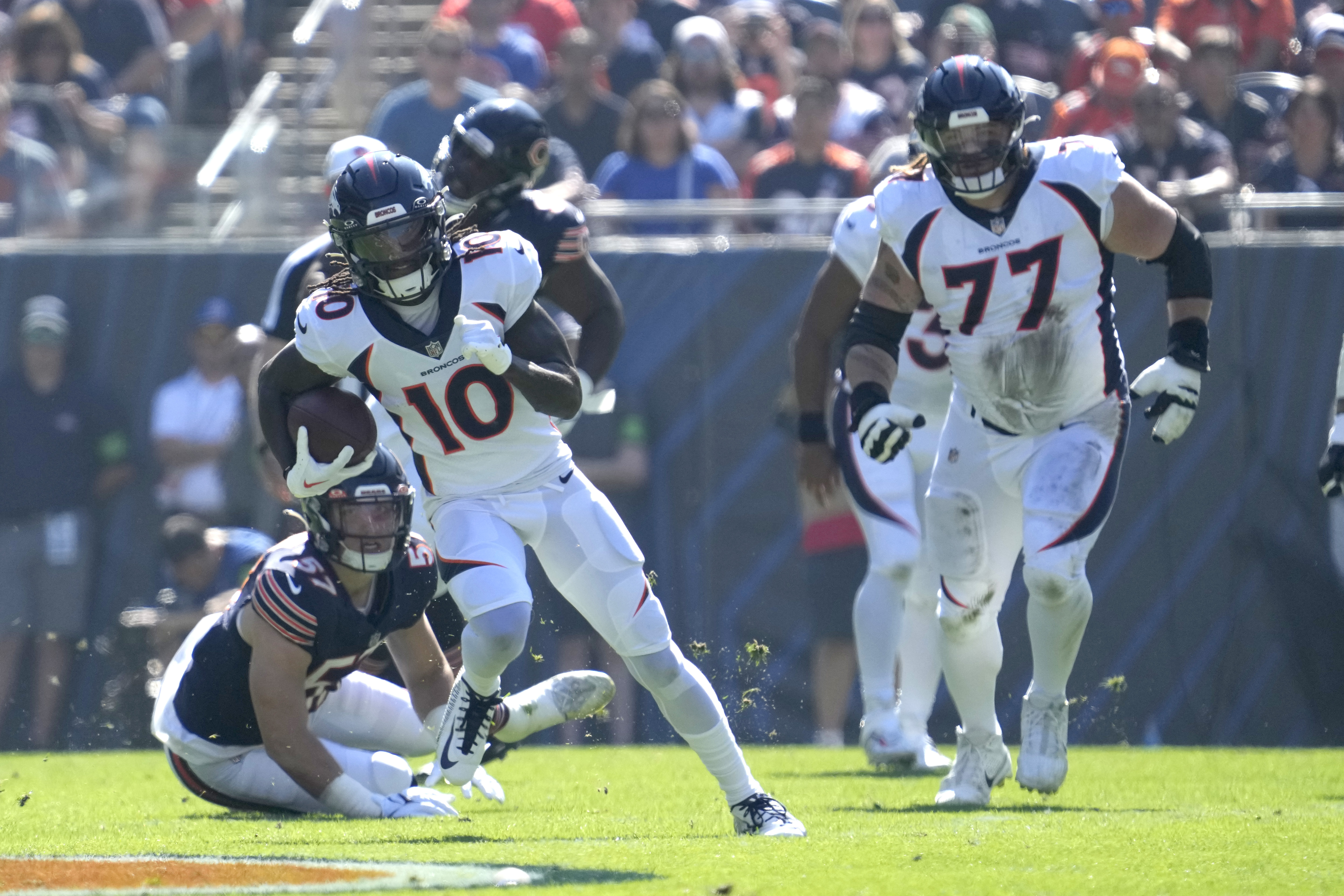 Denver Broncos wide receiver Jerry Jeudy (10) advances the ball off a reception from quarterback Russell Wilson during the first half of an NFL football game against the Chicago Bears Sunday, Oct. 1, 2023, in Chicago. 