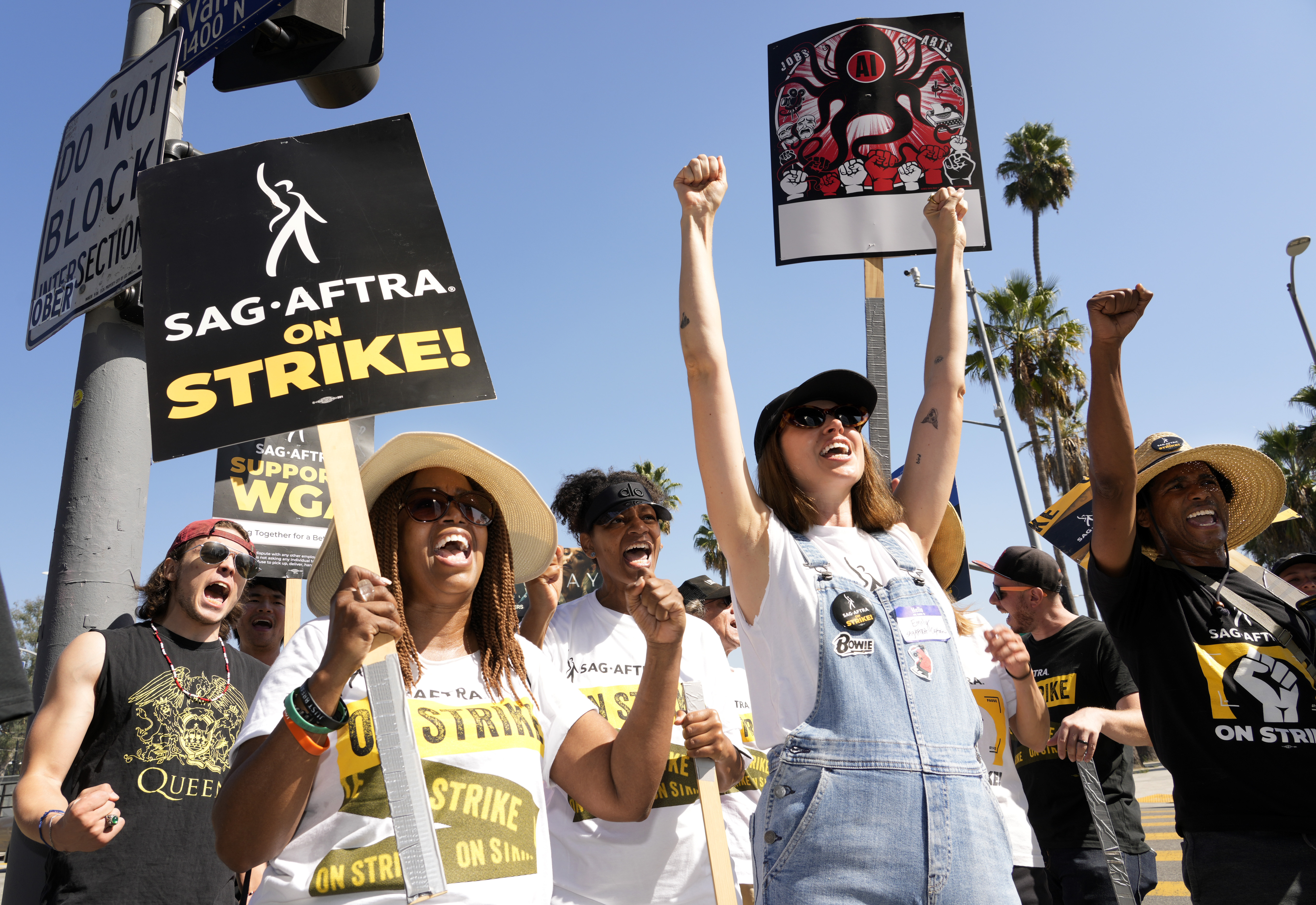 Striking actors Jennifer Leigh Warren, left, and Emily Kincaid, right, demonstrate outside Netflix studios, Tuesday, Oct. 17, in Los Angeles. 