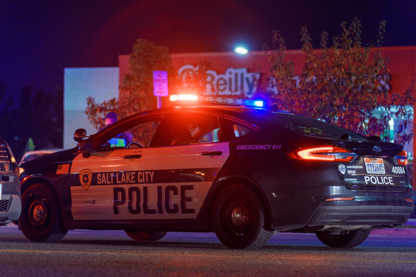 A Salt Lake City police car blocks traffic on Redwood Road near 1130 South after a deadly crash Friday night.
