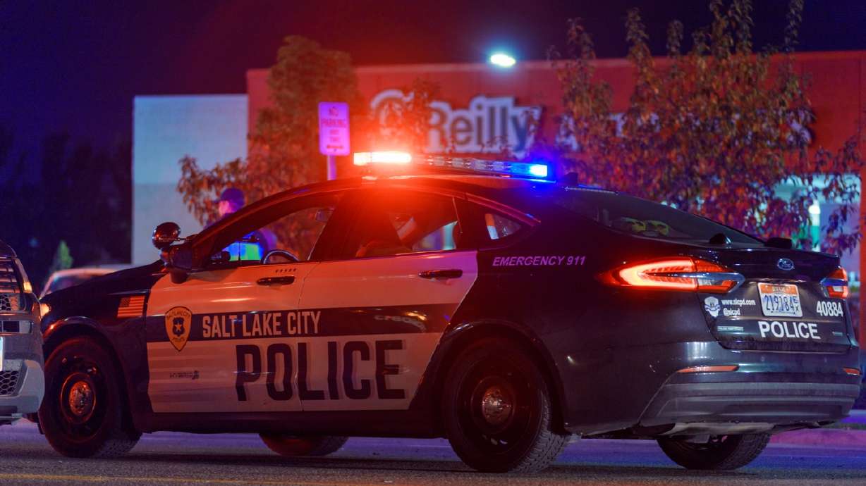 A Salt Lake City police car blocks traffic on Redwood Road near 1130 South after a deadly crash Friday night.