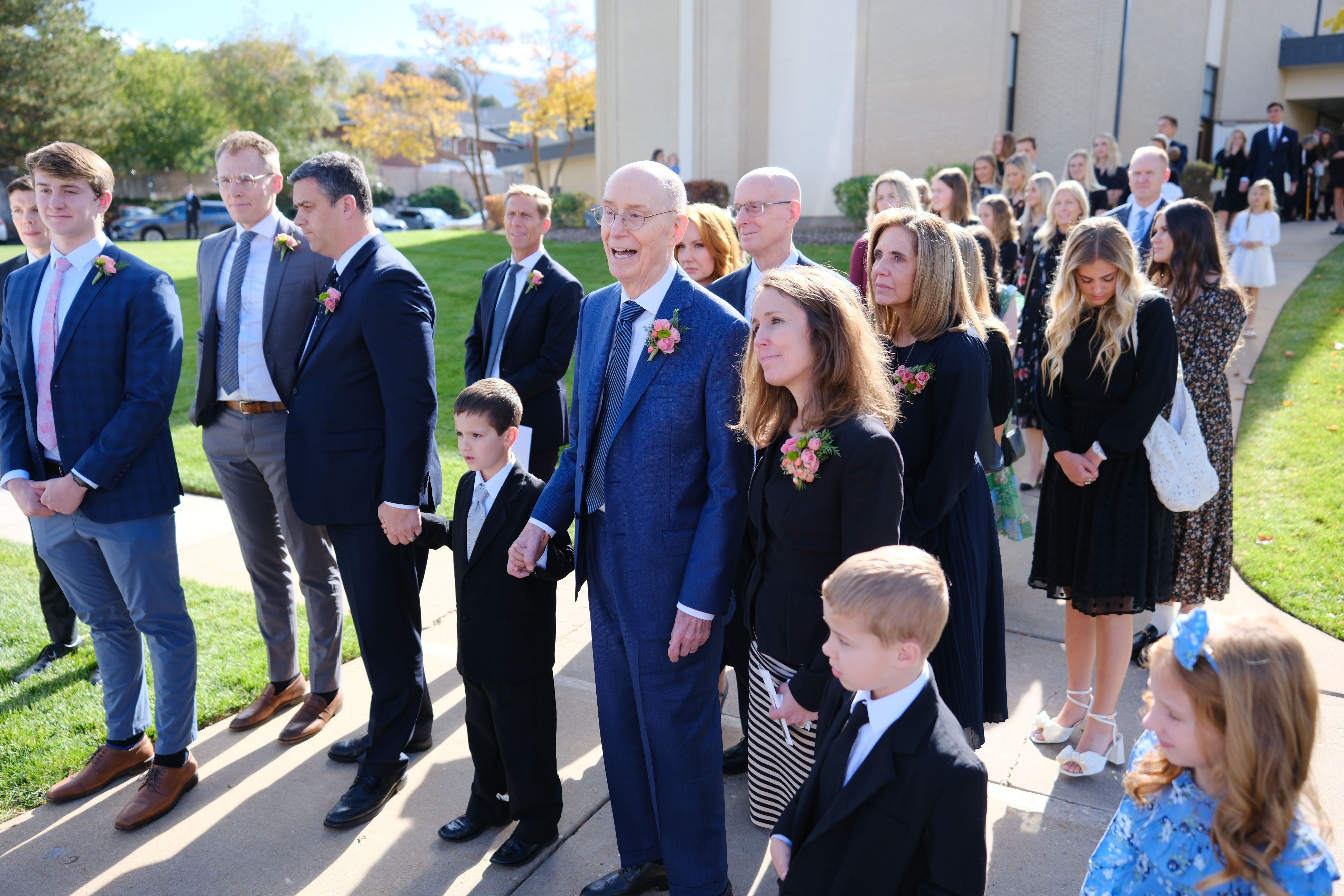 President Henry B. Eyring, second counselor in the First Presidency of The Church of Jesus Christ of Latter-day Saints, holds hands with a great-grandson after the funeral of his wife, Sister Kathleen Johnson Eyring, in Bountiful, on Saturday.