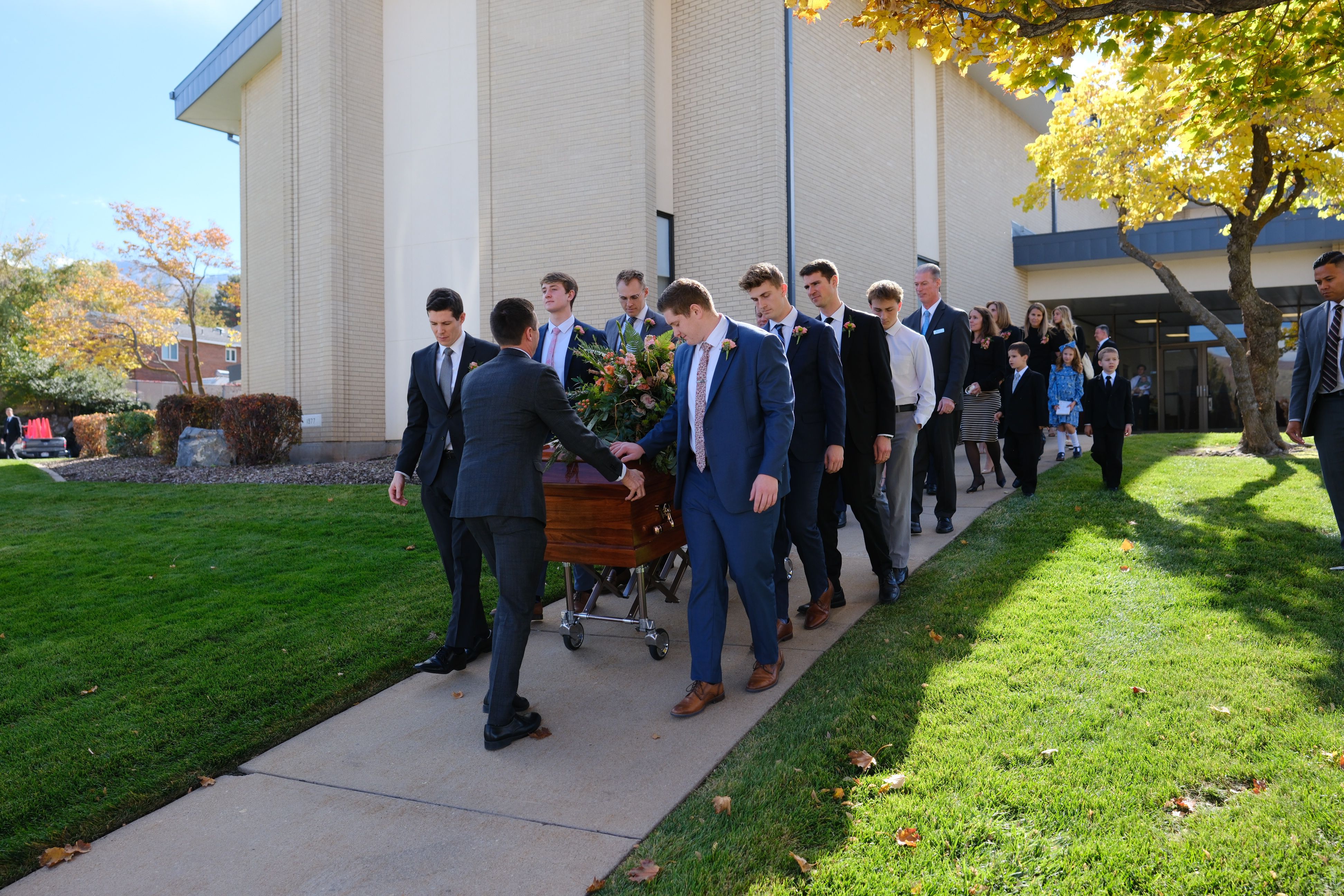 The pallbearers guide the casket of Sister Kathleen Johnson Eyring after her funeral in Bountiful, on Saturday. The pallbearers were Henry Christian Eyring, Spencer Edward Eyring, Matthew Paul Eyring, Andrew Stuart Eyring, James Matthew Eyring, Jacob Scott Eyring, John Bennion Eyring Jr. and Joshua Charles Peters.