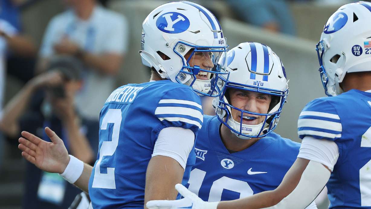 Brigham Young wide receiver Chase Roberts (2) celebrates his touchdown with quarterback Kedon Slovis (10) against the Texas Tech Red Raiders in Provo on Saturday, Oct. 21, 2023. BYU won 27-14.