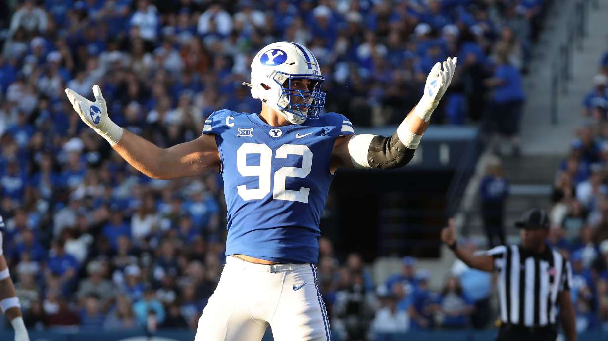 Brigham Young defensive end Tyler Batty (92) gestures to the fans to cheer louder against the Texas Tech Red Raiders in Provo on Saturday, Oct. 21, 2023. BYU won 27-14.