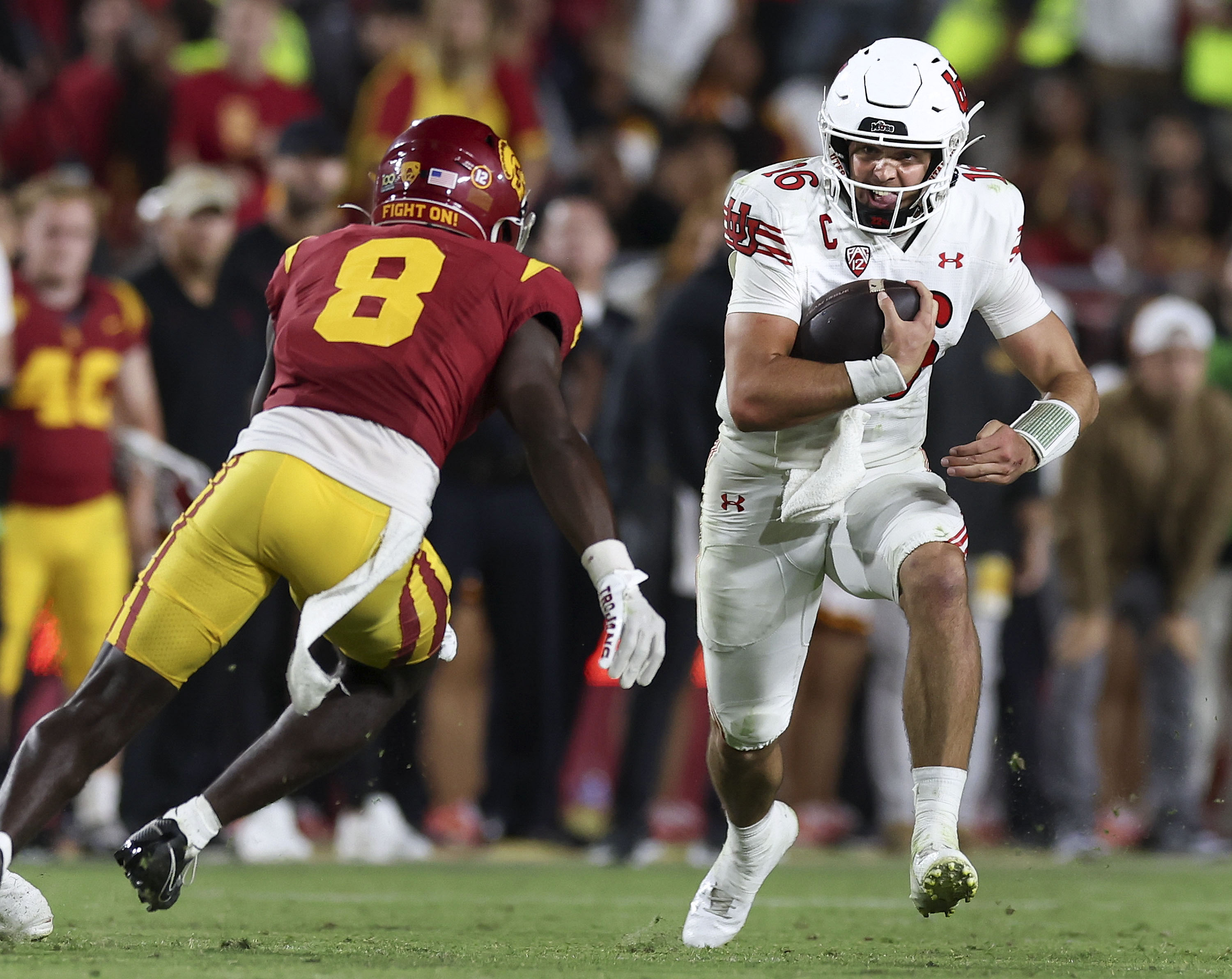 Utah Utes quarterback Bryson Barnes (16) runs past USC Trojans safety Zion Branch (8) as the Utes and the USC Trojans face each other at the Los Angeles Memorial Coliseum on Saturday, Oct. 21, 2023.