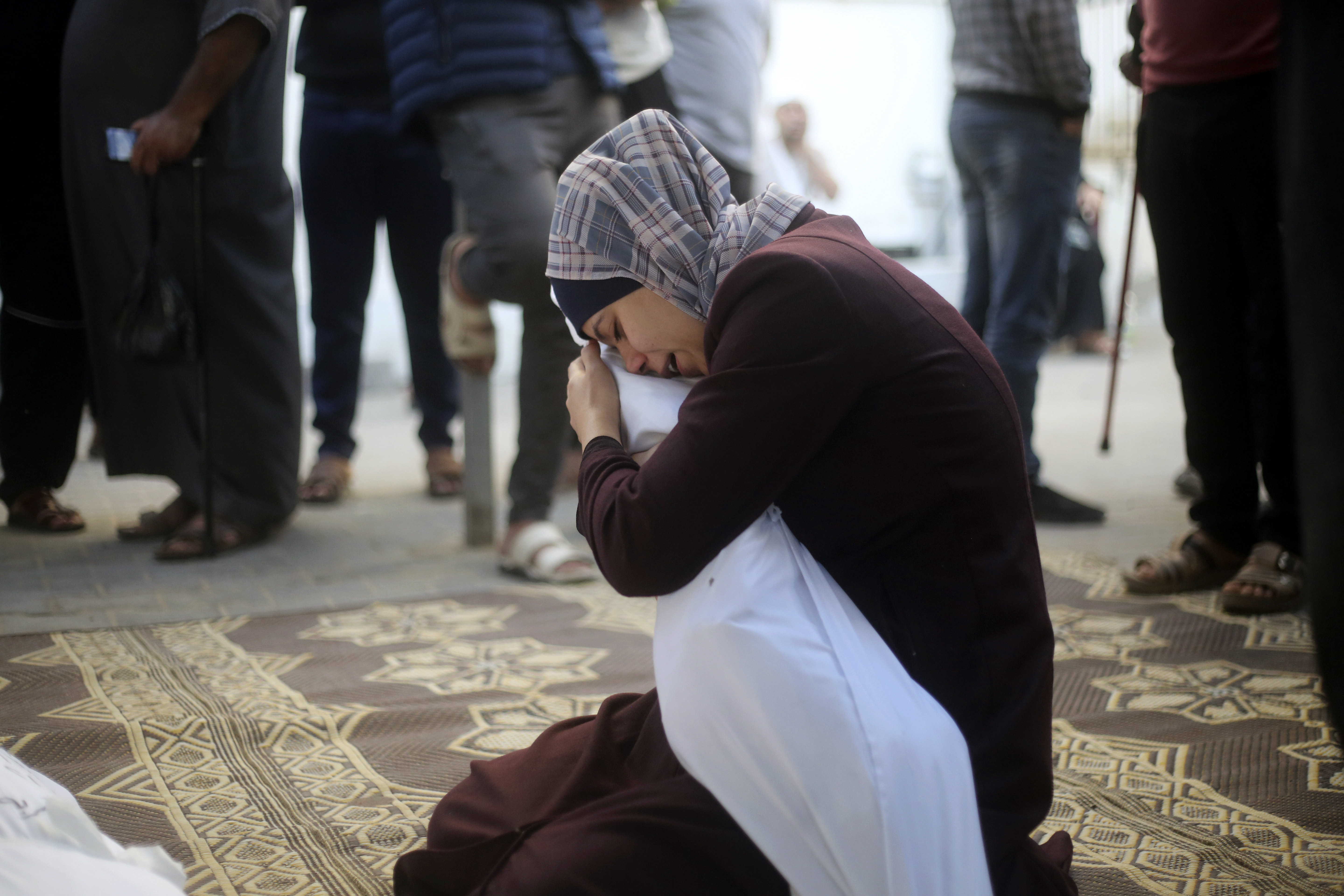 A Palestinian woman holds her cousin killed in the Israeli bombardment of the Gaza Strip in Rafah on Saturday.