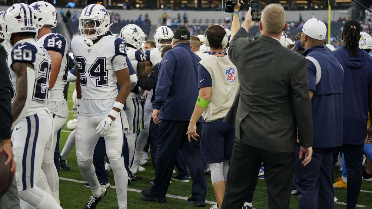Dallas Cowboys and Los Angeles Chargers players get into a shoving match before an NFL football game Monday, Oct. 16, 2023, in Inglewood, Calif.