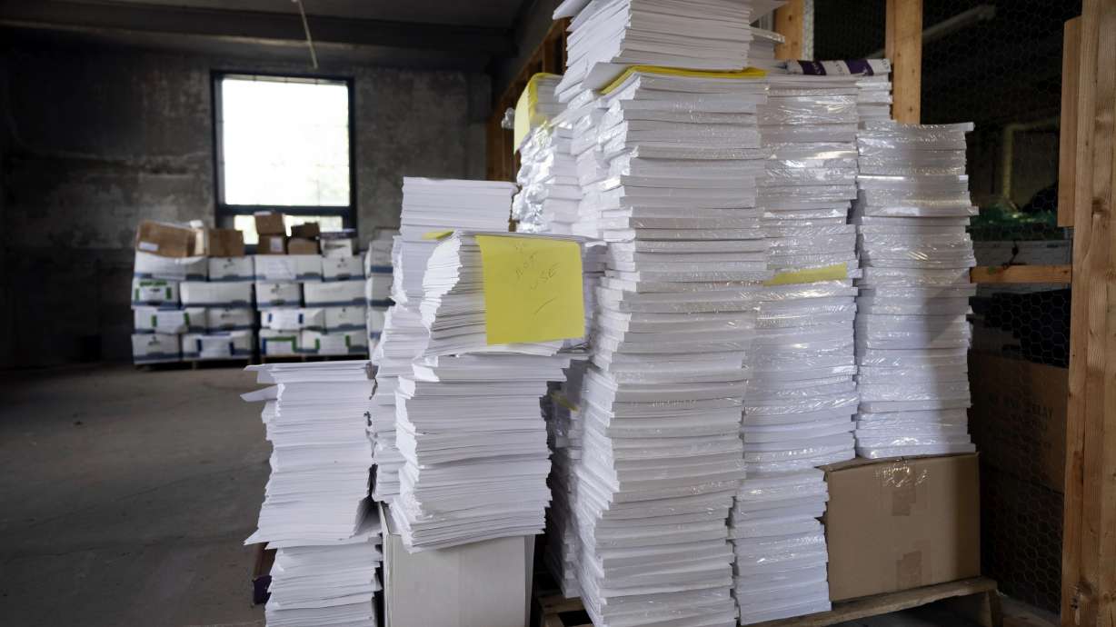 Stacks of paper too thick for Luzerne County's election equipment are seen in the county's warehouse in Wilkes-Barre, Pa., Sept. 13. Worker turnover, understaffing and lack of training cause mistakes in U.S. elections that have been twisted by conspiracy theorists.