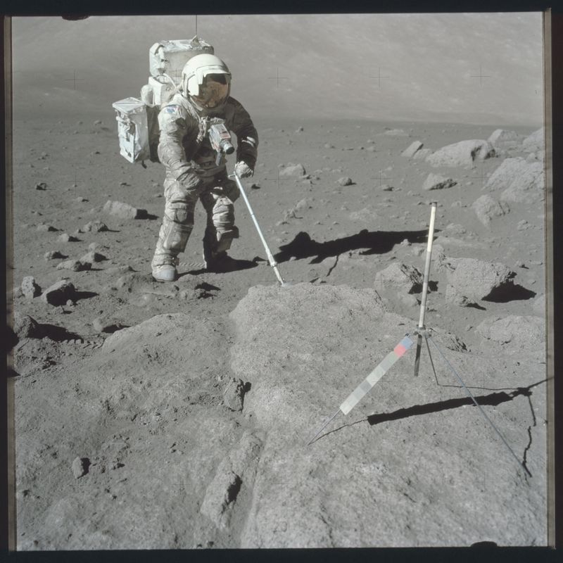 Scientist-astronaut Harrison Schmitt, Apollo 17 lunar module pilot, uses an adjustable sampling scoop to retrieve lunar samples during the second Apollo 17 extravehicular activity in this Dec. 12, 1972, NASA handout photo.