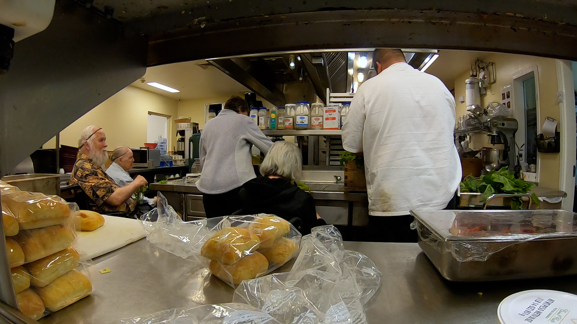 David Bench cooking with residents in the facility kitchen.