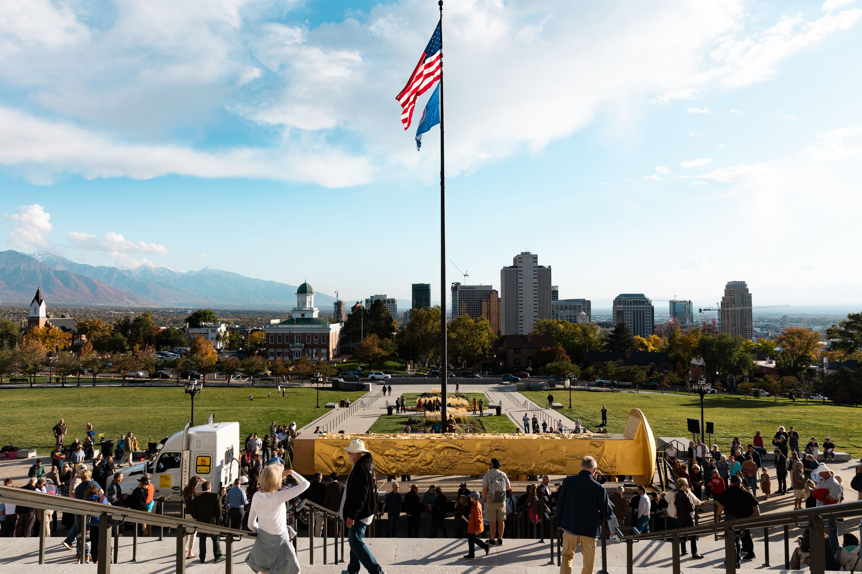Attendees step up to see the Golden Spike Monument after its arrival in front of the state Capitol in Salt Lake City on Oct. 23, 2023. The Utah Legislature voted Wednesday to make its future home in Brigham City, one of two new state monuments.