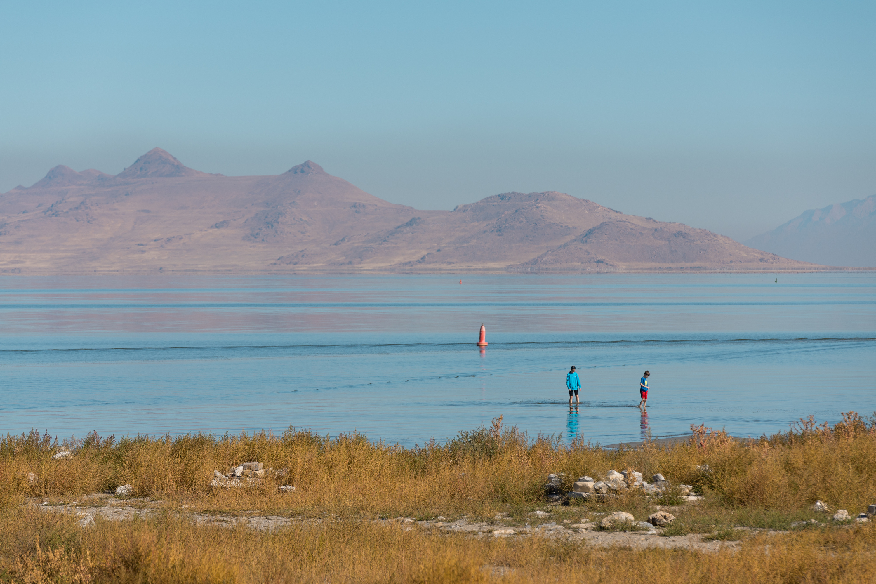 A family walks in the water at Great Salt Lake State Park in Magna on Oct. 6.