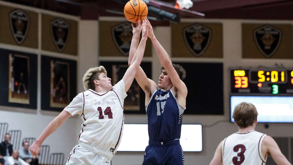Corner Canyon’s Brody Kozlowski shoots over Lone Peak’s Luke Fotheringham in a high school boys basketball game in Highland on Tuesday, Jan. 24, 2023.