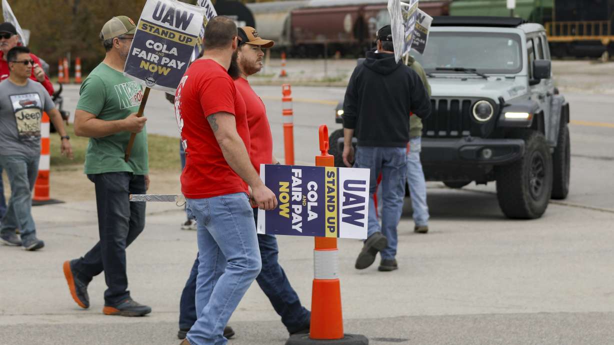 Strikers picket during the ongoing United Auto Workers strike at the Stellantis Toledo Assembly Complex on Wednesday in Toledo, Ohio. The United Auto Workers union says it has reached a tentative contract agreement with Ford.