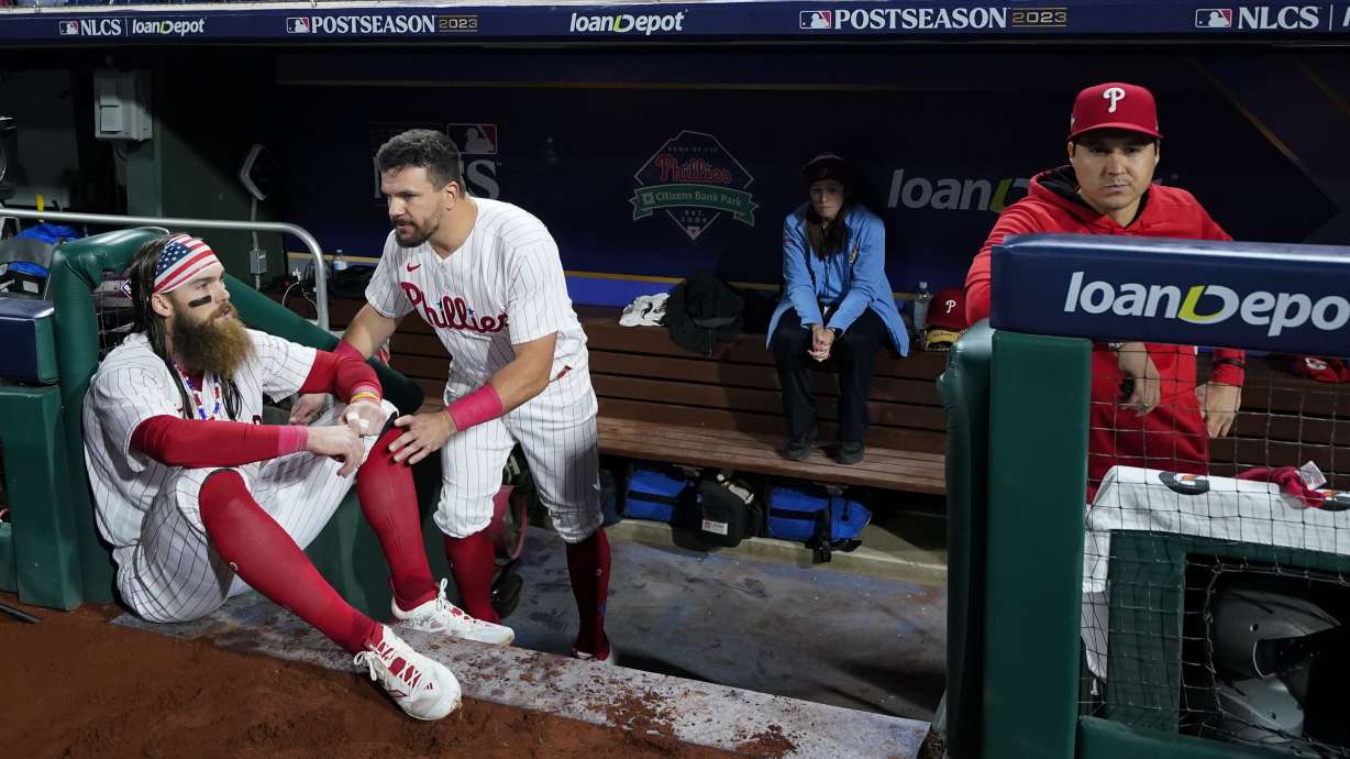 Philadelphia Phillies center fielder Brandon Marsh and designated hitter Kyle Schwarber react after the team's loss to the Arizona Diamondbacks in Game 7 of the baseball NL Championship Series in Philadelphia Tuesday, Oct. 24, 2023.