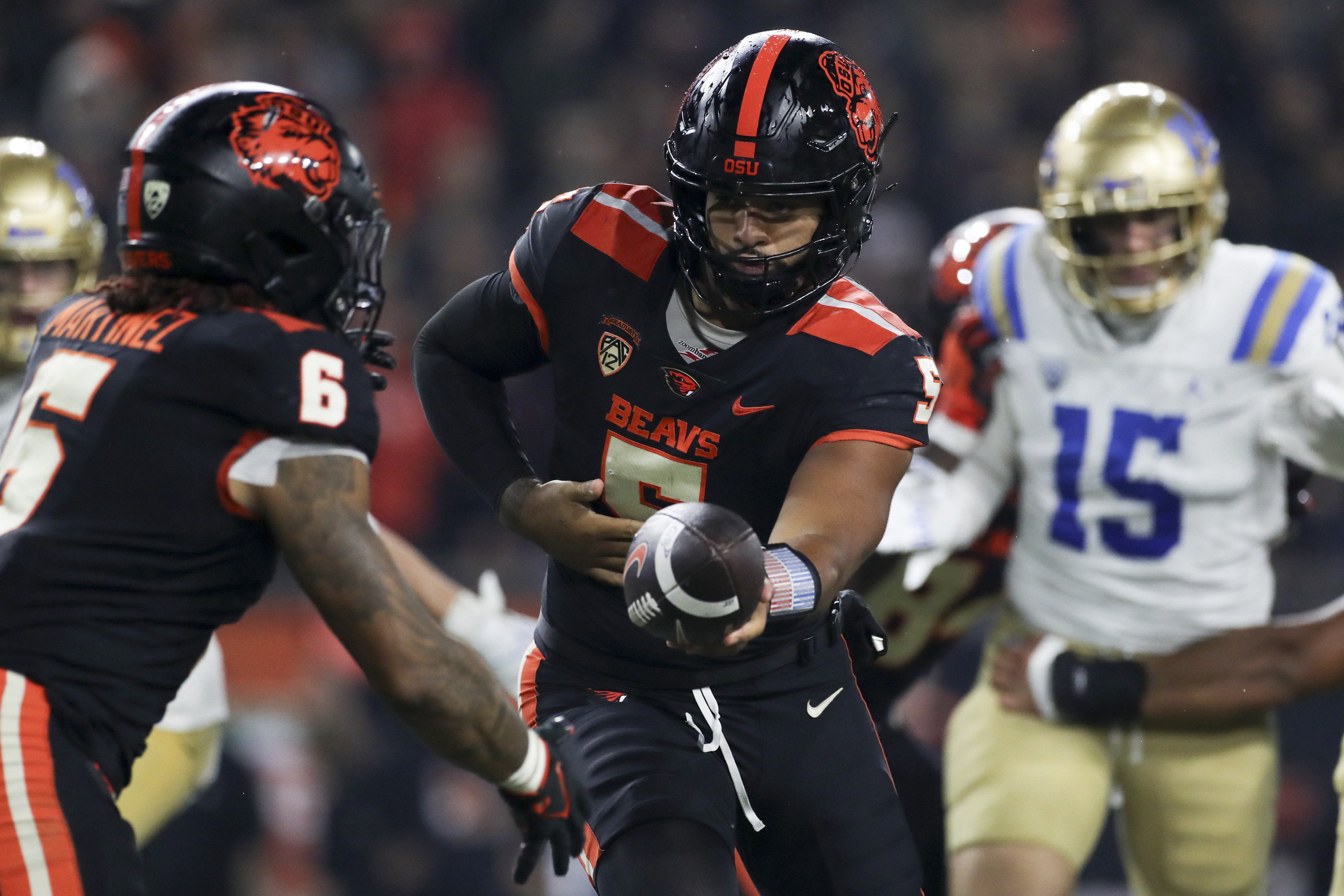 Oregon State quarterback DJ Uiagalelei (5) hands off the ball to running back Damien Martinez (6) during the second half of the team's NCAA college football game against UCLA on Saturday, Oct. 14, 2023, in Corvallis, Ore. 