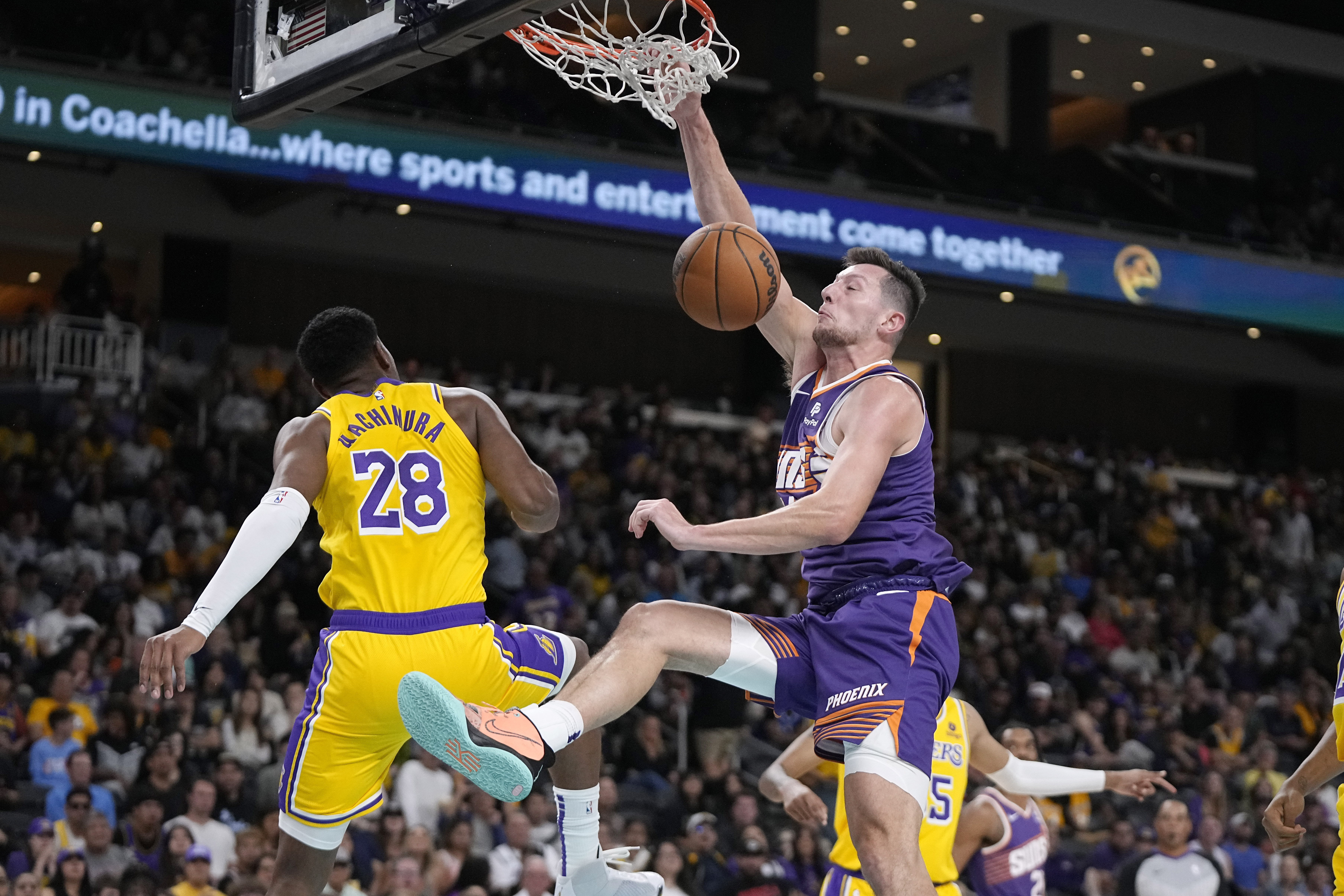 Phoenix Suns forward Drew Eubanks, right, dunks as Los Angeles Lakers forward Rui Hachimura defends during the second half of an NBA preseason basketball game Thursday, Oct. 19, 2023, in Thousand Palms, Calif. 