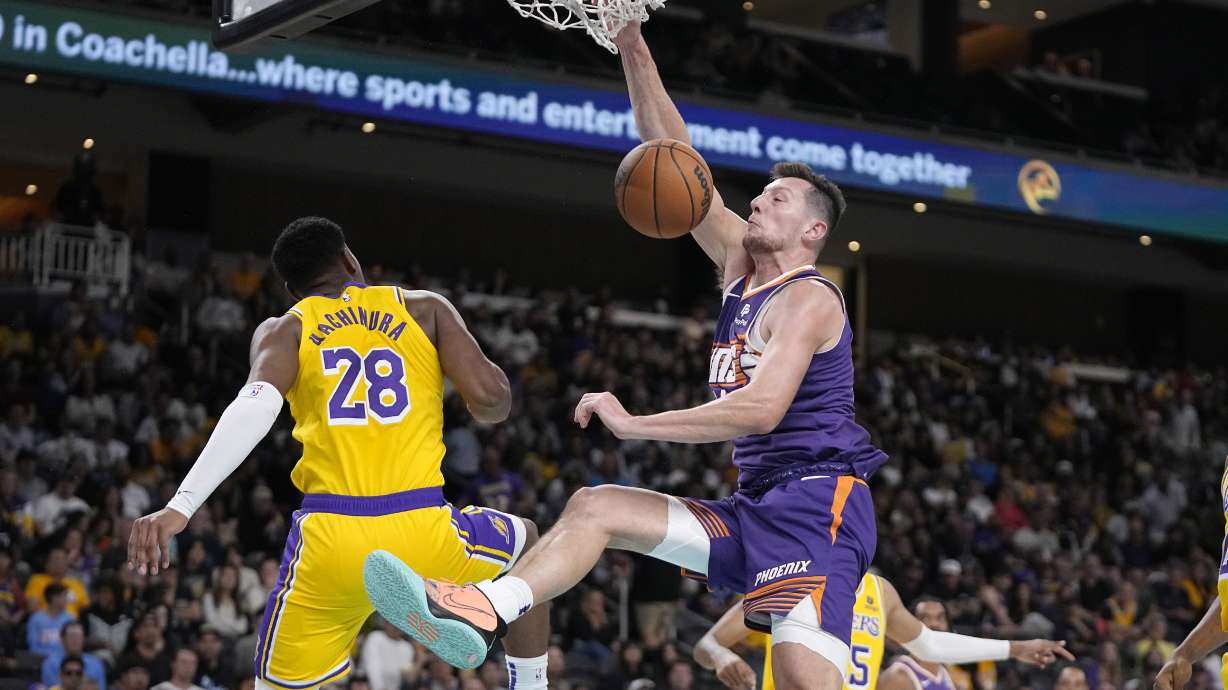 Phoenix Suns forward Drew Eubanks, right, dunks as Los Angeles Lakers forward Rui Hachimura defends during the second half of an NBA preseason basketball game Thursday, Oct. 19, 2023, in Thousand Palms, Calif.