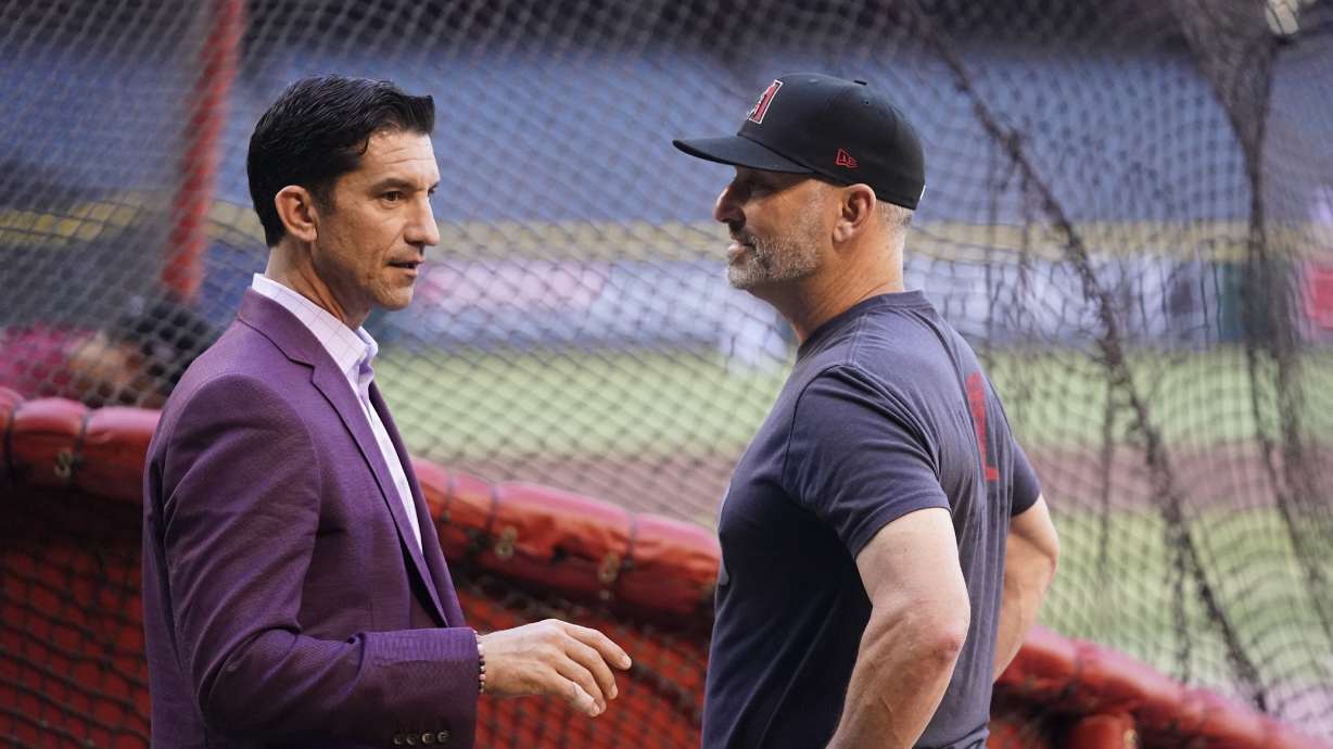 Arizona Diamondbacks manager Torey Lovullo, right, talks with Diamondbacks general manager Mike Hazen before Game 3 of a baseball NL Division Series against the Los Angeles Dodgers, Wednesday, Oct. 11, 2023, in Phoenix.