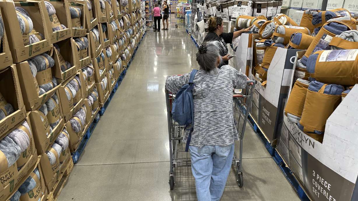 Shoppers look over blankets on sale in a Costco warehouse on Aug. 24, in Sheridan, Colo. The nation's economy expanded at a 4.9% annual rate last quarter, the government reported Thursday.