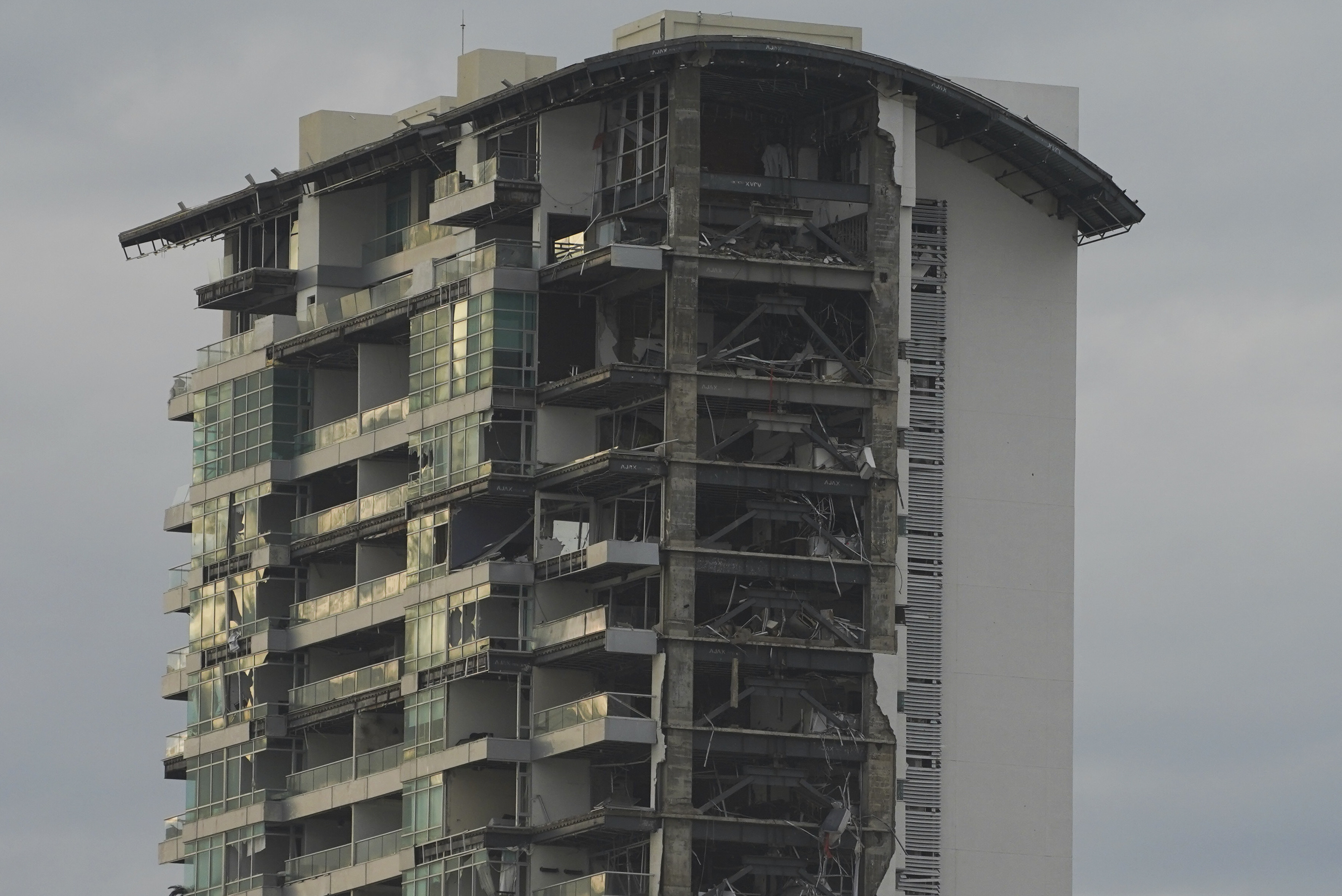 A damaged building stands after Hurricane Otis ripped through Acapulco, Mexico, Wednesday. Mexican authorities say there are 27 confirmed deaths and four people missing.