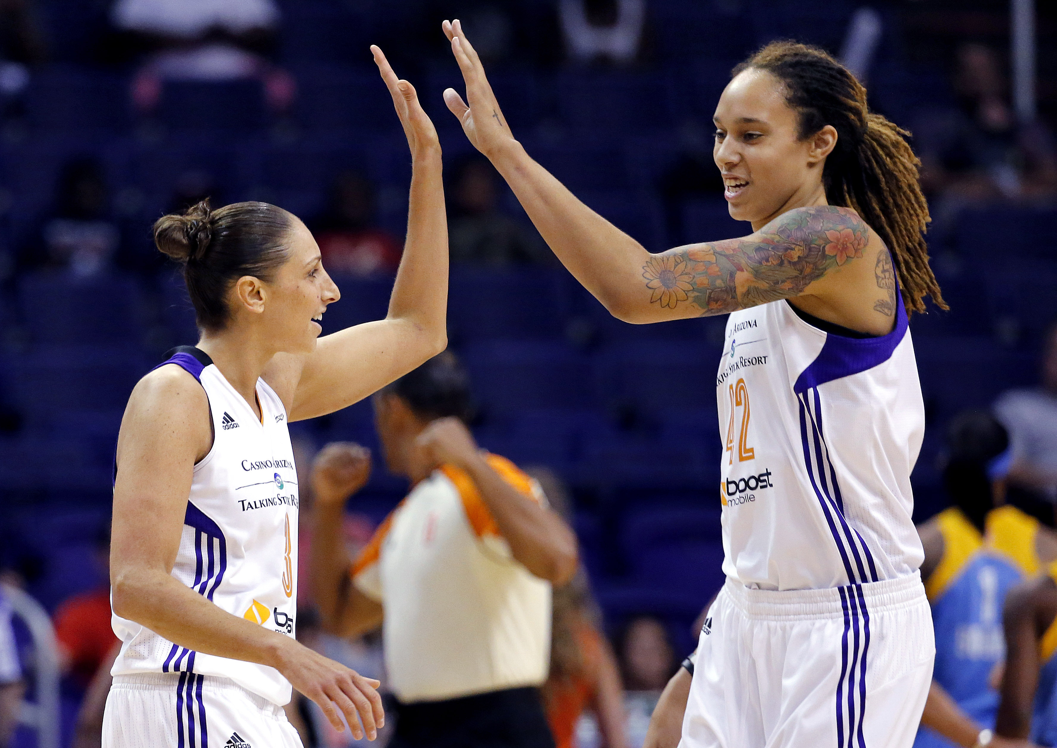 FILE - Phoenix Mercury guard Diana Taurasi, left, high-fives teammate Brittney Griner during the first half of a WNBA basketball game against the Chicago Sky, on July 2, 2014, in Phoenix. Five-time Olympic gold medalist Diana Taurasi and Brittney Griner head up the USA Basketball Women’s National Team roster of 16 players announced Thursday, Oct. 26, 2023, for a pair of November exhibition games and training camp in Atlanta.