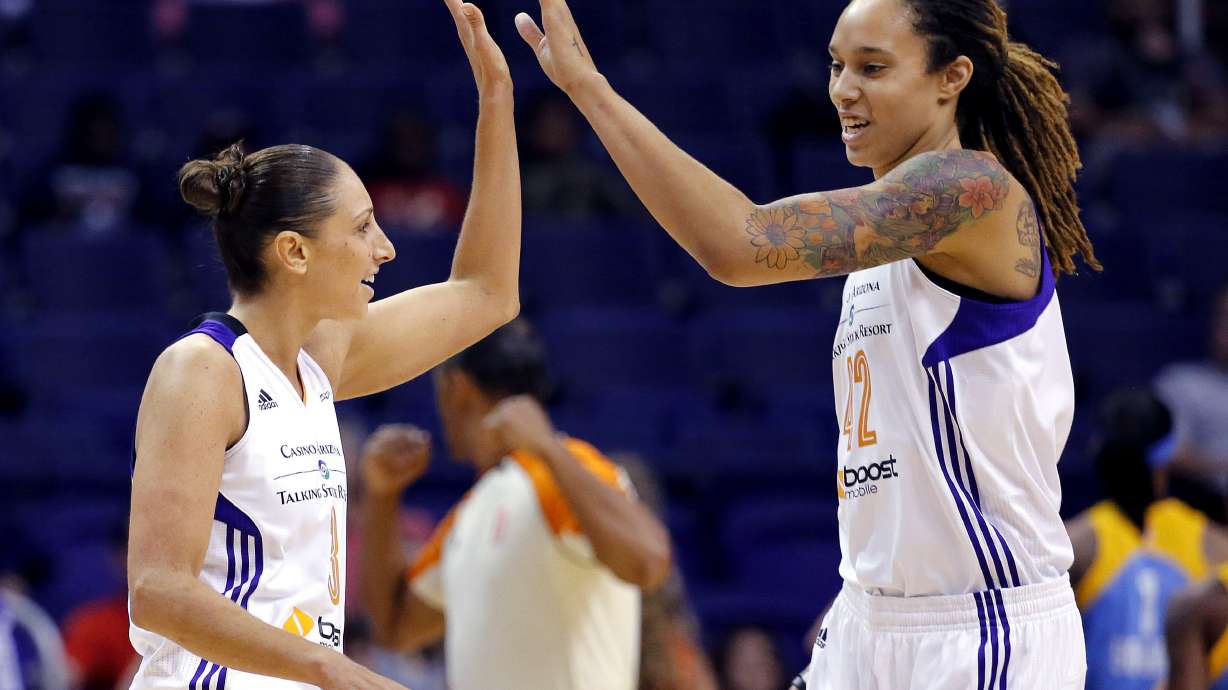 FILE - Phoenix Mercury guard Diana Taurasi, left, high-fives teammate Brittney Griner during the first half of a WNBA basketball game against the Chicago Sky, on July 2, 2014, in Phoenix. Five-time Olympic gold medalist Diana Taurasi and Brittney Griner head up the USA Basketball Women’s National Team roster of 16 players announced Thursday, Oct. 26, 2023, for a pair of November exhibition games and training camp in Atlanta.