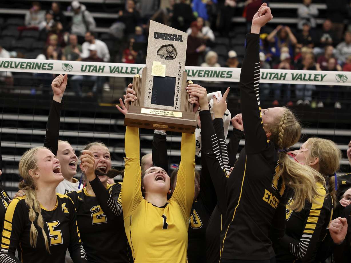 Emery High School celebrates their 3A state volleyball championship win against Morgan High School at Utah Valley University in Orem on Thursday, Oct. 26, 2023.