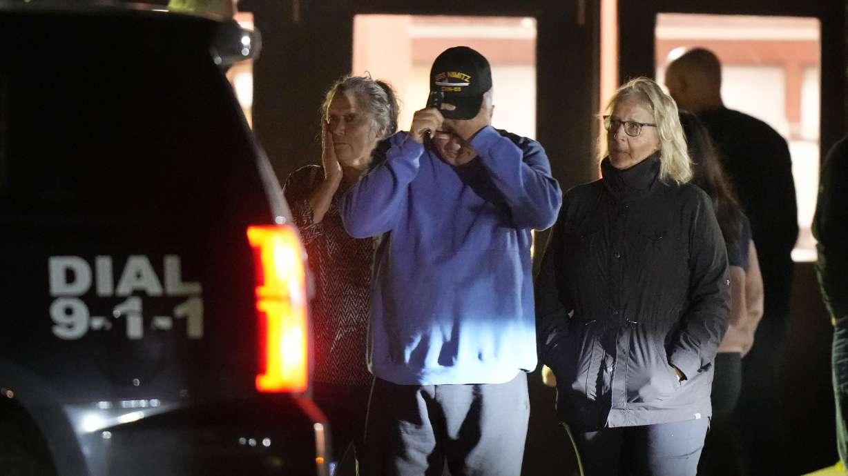 People depart a reunification center early Thursday at Auburn Middle School, in Auburn, Maine, after shootings in Lewiston. Shocked and fearful Maine residents are keeping to their homes for a second night as hundreds of police and FBI agents search intently for Robert Card, a U.S. Army reservist authorities say fatally shot 18 people at a bowling alley and a bar.