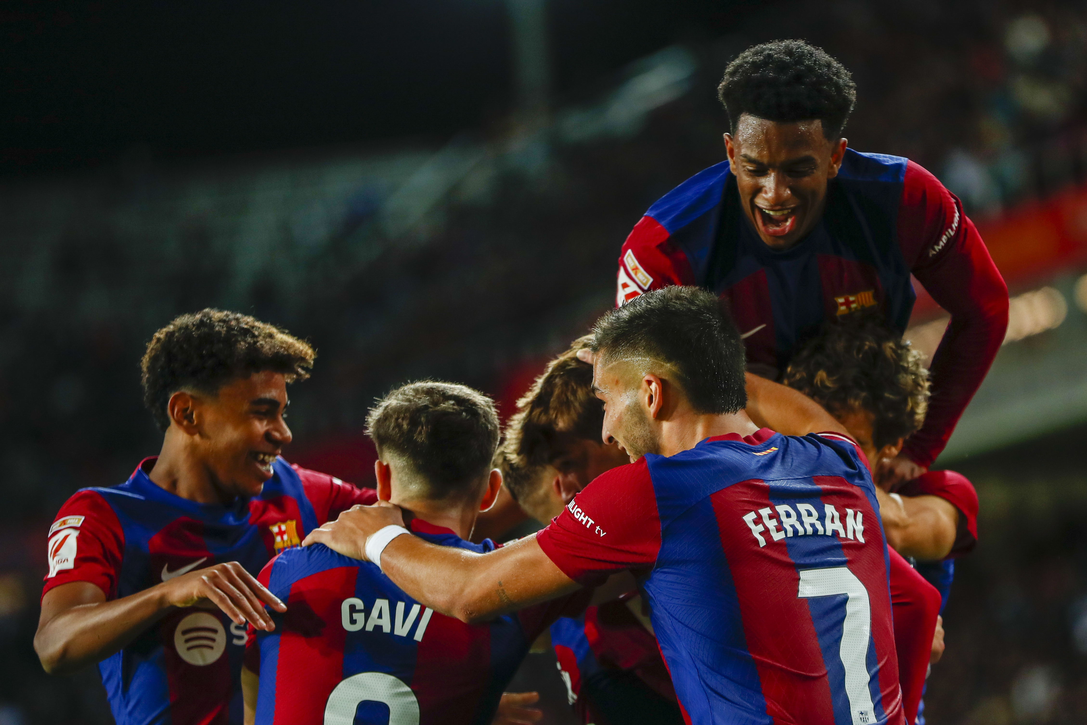 Barcelona's Marc Guiu celebrates with teammates after scoring his side's opening goal during a Spanish La Liga soccer match between Barcelona and Athletic Bilbao, at the Olympic Stadium of Montjuic in Barcelona, Spain, Sunday, Oct. 22, 2023.