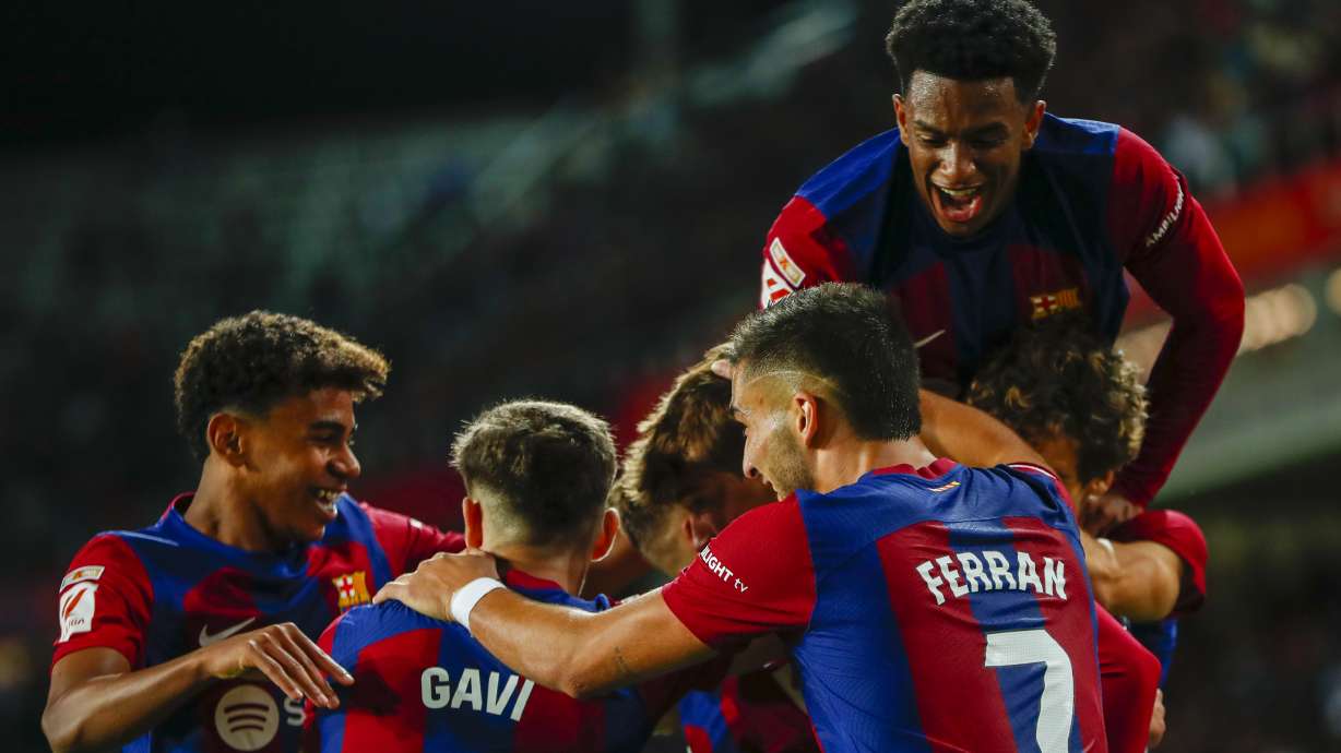 Barcelona's Marc Guiu celebrates with teammates after scoring his side's opening goal during a Spanish La Liga soccer match between Barcelona and Athletic Bilbao, at the Olympic Stadium of Montjuic in Barcelona, Spain, Sunday, Oct. 22, 2023.