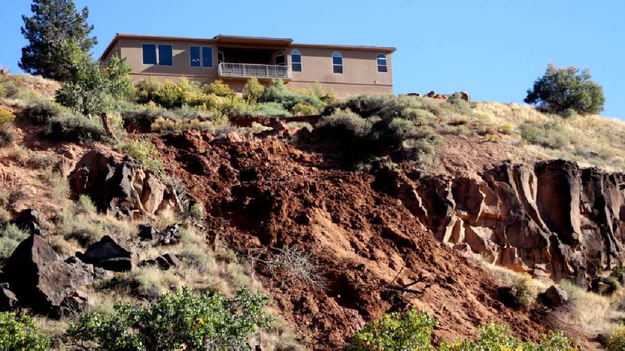 A landslide behind the Poulsen home on 560 West in La Verkin overlooking the Confluence Park threatens to claim the Poulsen home and the one next to it, Monday.