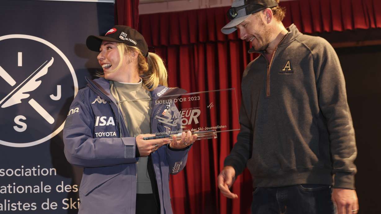 United States' Mikaela Shiffrin, left, receives the Golden Skier award from US ski legend Bode Miller, ahead of the alpine ski season's opening races, in Soelden, Austria, Friday, Oct. 27, 2023.