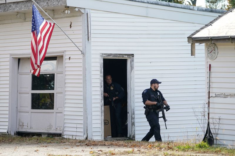 Members of law enforcement search a farm, as the search for the suspect in the deadly mass shootings in Lewiston continued, in Lisbon Falls, Maine, Friday. The suspect has been found dead.